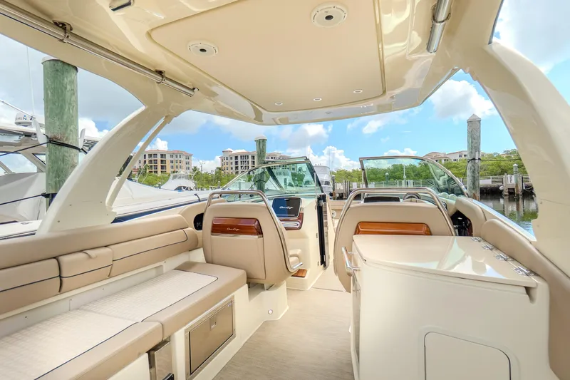 Slide: The Image of 2023 Chris-Craft Launch 31 GT interior with luxurious seating and modern design at a marina. - 13
