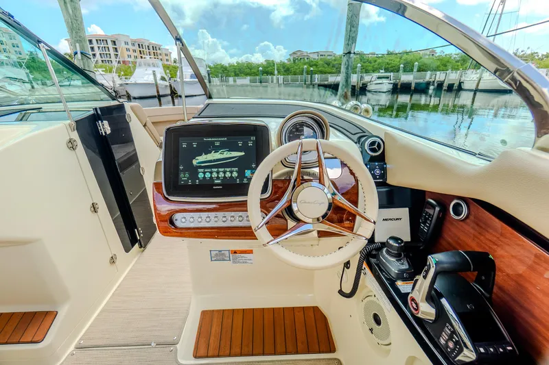 Slide: The Image of 2023 Chris-Craft Launch 31 GT dashboard with steering wheel and navigation display. - 19