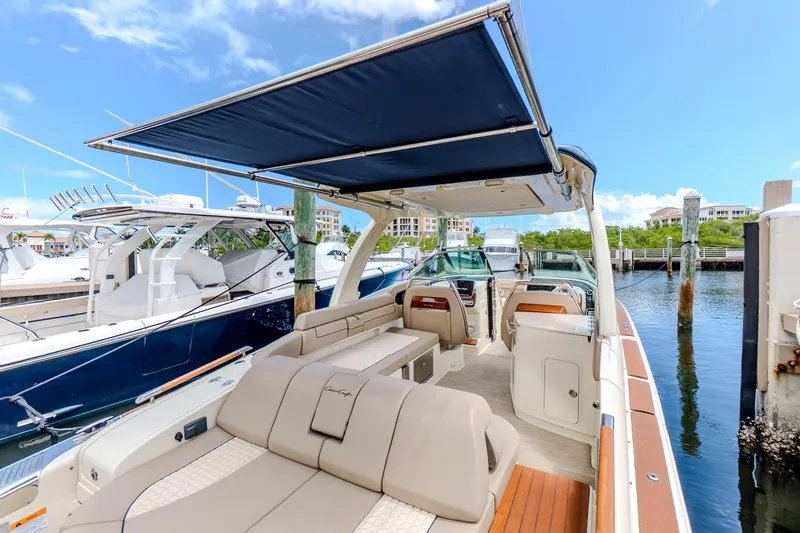 Slide: The Image of 2023 Chris-Craft Launch 31 GT luxury boat docked, featuring spacious seating and elegant design. - 34