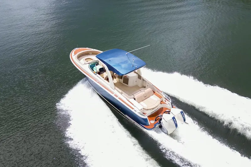 Slide: The Image of 2023 Chris-Craft Launch 31 GT cruising on water, showcasing luxury design and powerful engines. - 37