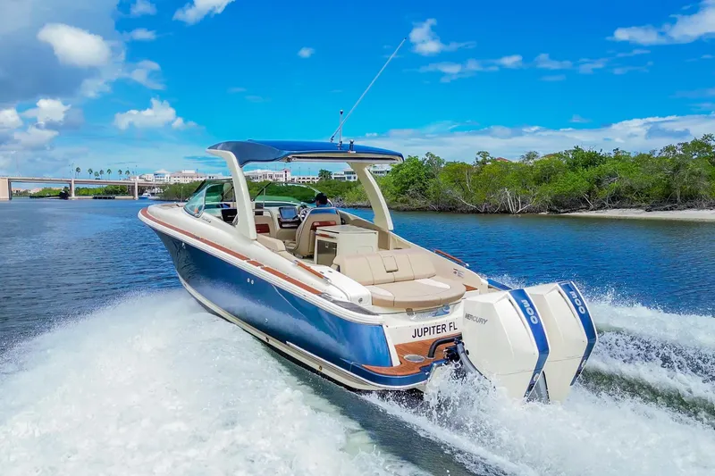 Slide: The Image of 2023 Chris-Craft Launch 31 GT boat cruising on a sunny day, featuring dual Mercury engines. - 4