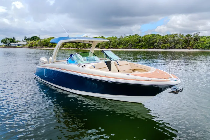 Slide: The Image of 2023 Chris-Craft Launch 31 GT boat on calm water, showcasing sleek design and luxury features. - 42