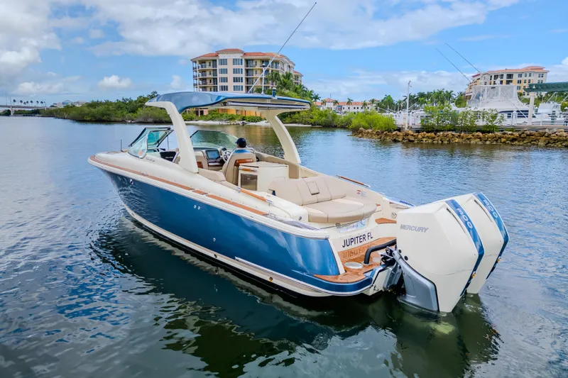 Slide: The Image of 2023 Chris-Craft Launch 31 GT boat on water, featuring sleek design and powerful Mercury engines. - 43