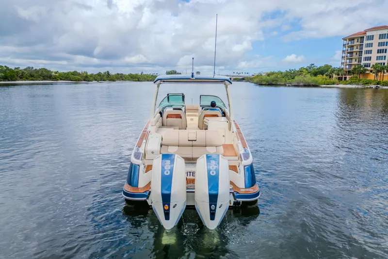 Slide: The Image of 2023 Chris-Craft Launch 31 GT boat on calm water, rear view with twin engines. - 44
