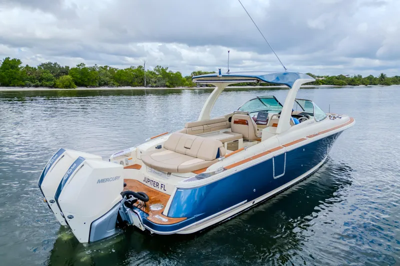 Slide: The Image of 2023 Chris-Craft Launch 31 GT boat on calm water, featuring sleek design and luxurious seating. - 45