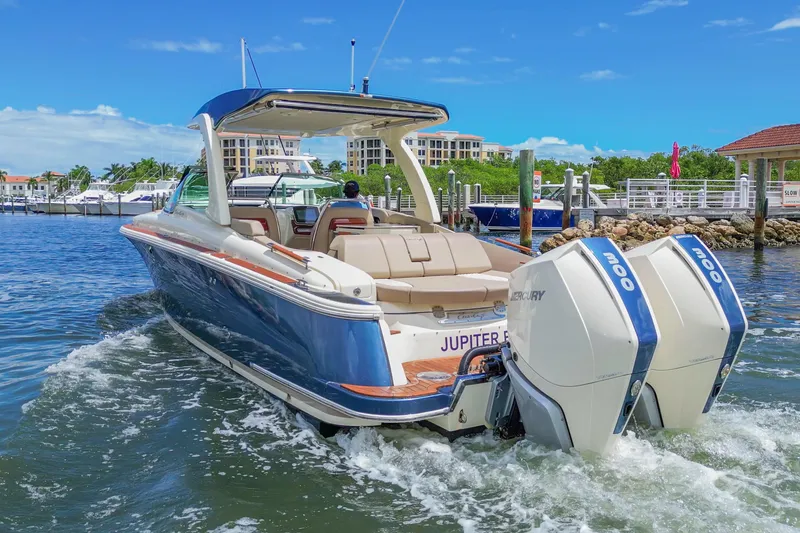 Slide: The Image of 2023 Chris-Craft Launch 31 GT boat with dual Mercury engines in a marina setting. - 5