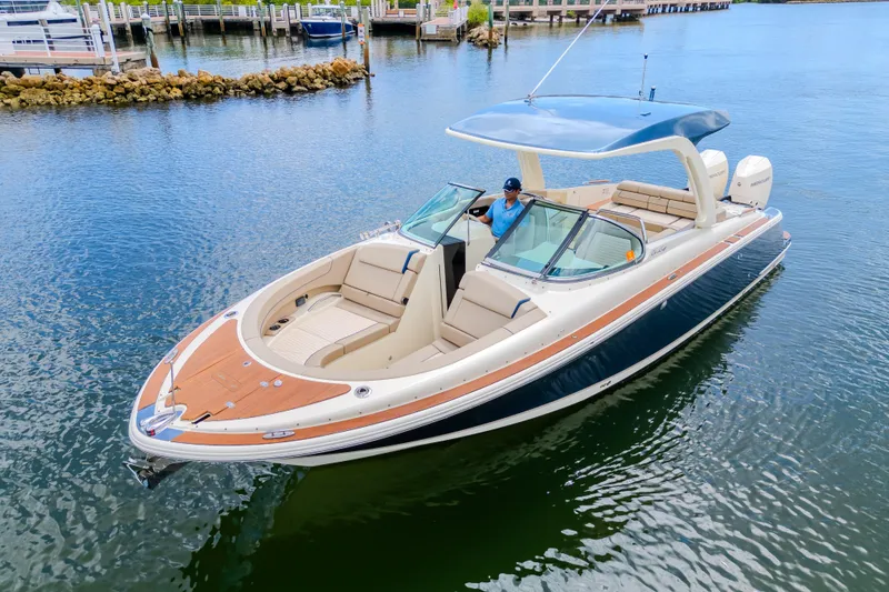 Slide: The Image of 2023 Chris-Craft Launch 31 GT boat on water, featuring elegant design and spacious seating. - 6