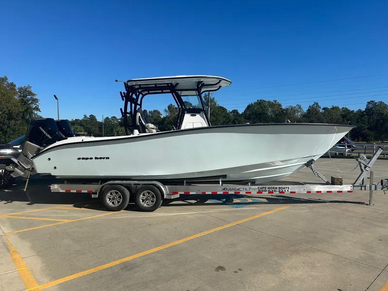 Slide: The Image of 2025 Cape Horn 28XS boat on trailer in parking lot under clear blue sky. - 4
