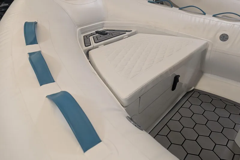 Slide: The Image of 2025 Tide Craft Nantucket 12 boat interior with teal accents and hexagonal flooring. - 2