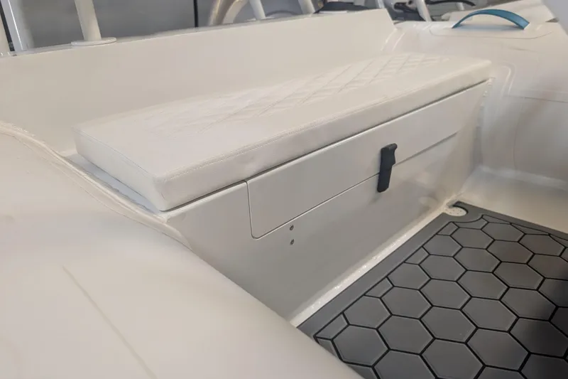 Slide: The Image of 2025 Tide Craft Nantucket 12 boat interior with cushioned seat and hexagonal floor mat. - 5