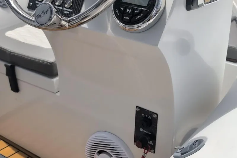 Slide: The Image of Steering console of 2025 Tide Craft Nantucket 12 boat with audio controls. - 6