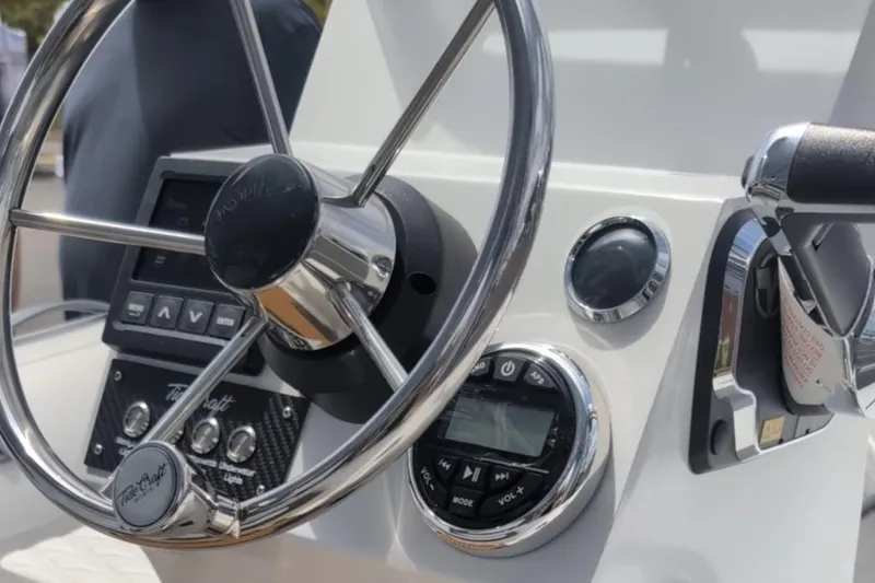 Slide: The Image of Steering console of 2025 Tide Craft Custom Teal, Black and White Nantucket 12 boat. - 7