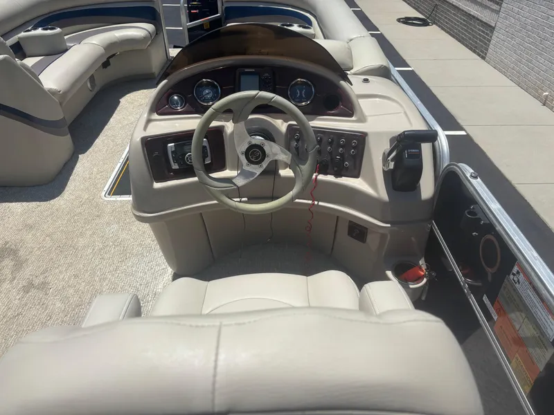 Slide: The Image of Interior view of 2013 South Bay 522CR TT boat cockpit with steering wheel and controls. - 3