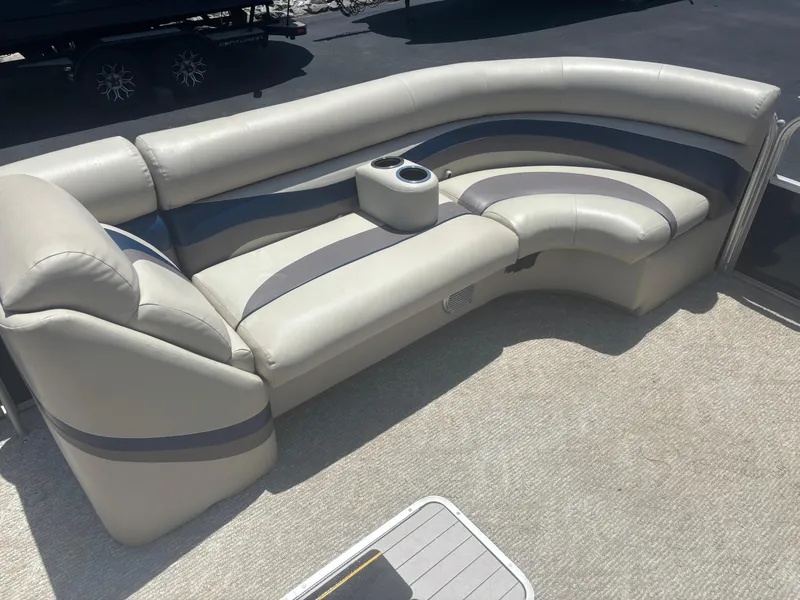 Slide: The Image of 2013 South Bay 522CR TT pontoon boat interior with curved seating and cup holders. - 4