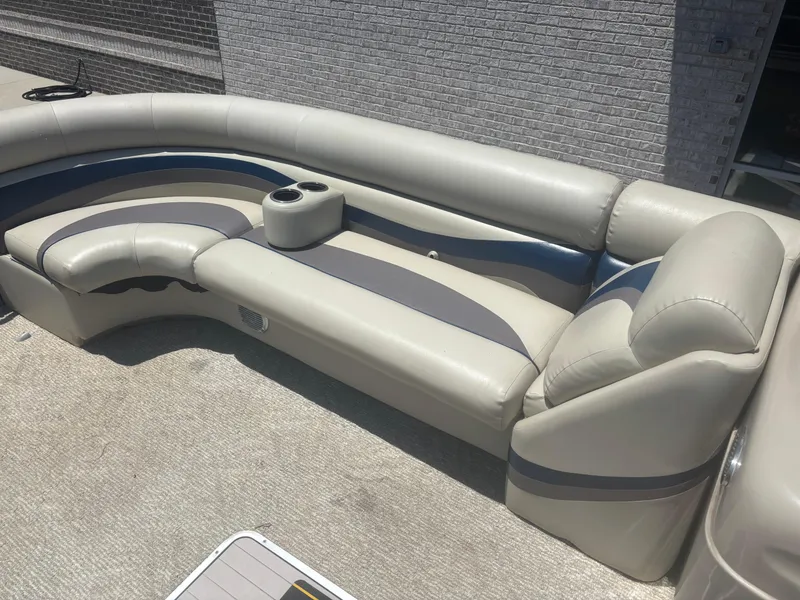 Slide: The Image of 2013 South Bay 522CR TT pontoon boat interior with beige and blue seating. - 5