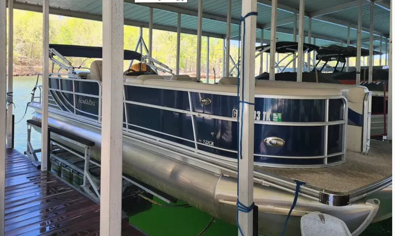 Slide: The Image of 2013 South Bay 522CR TT pontoon boat docked in a covered marina. - 6