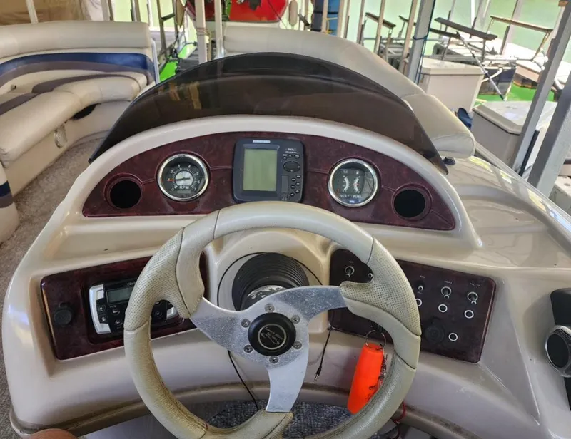 Slide: The Image of Steering console of a 2013 South Bay 522CR TT pontoon boat with gauges and controls. - 8