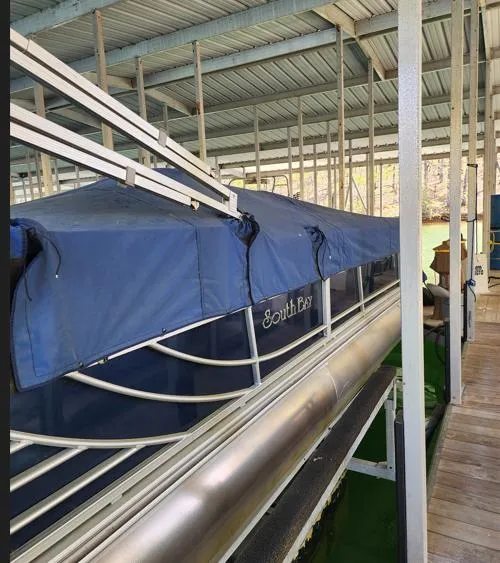 Slide: The Image of 2013 South Bay 522CR TT pontoon boat docked with blue cover. - 9