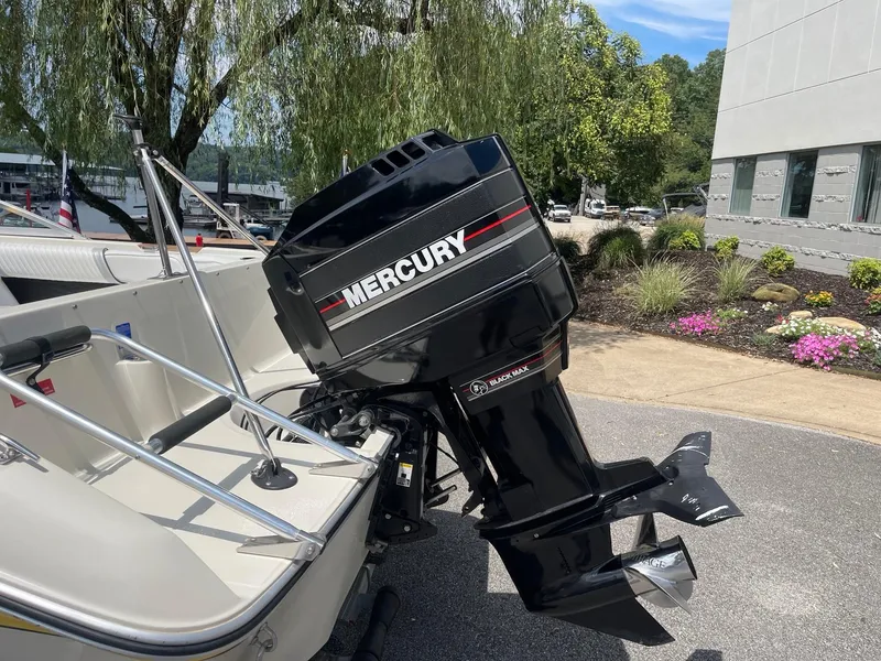 Slide: The Image of 1990 Sea Ray 180 Bowrider with Mercury Black Max outboard motor, parked outdoors. - 5