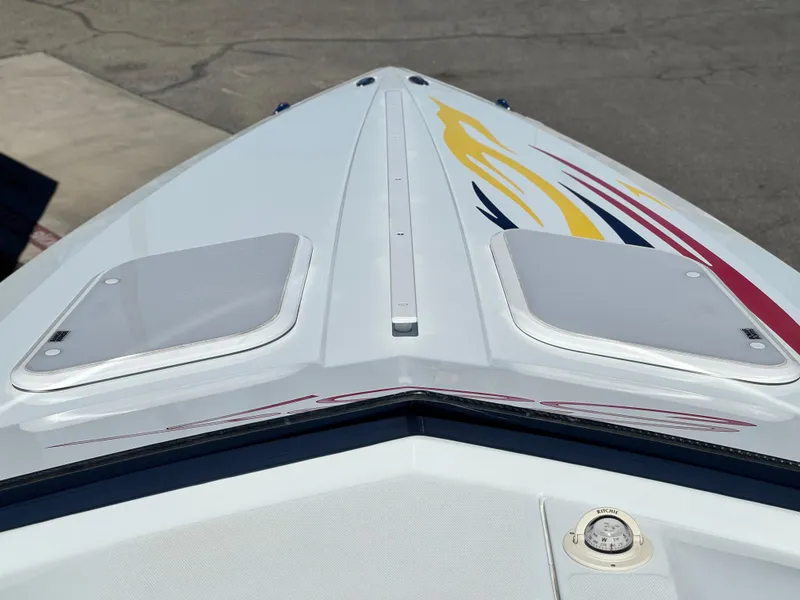 Slide: The Image of 2007 Baja 26 Outlaw boat bow with colorful graphics and deck hatches. - 10