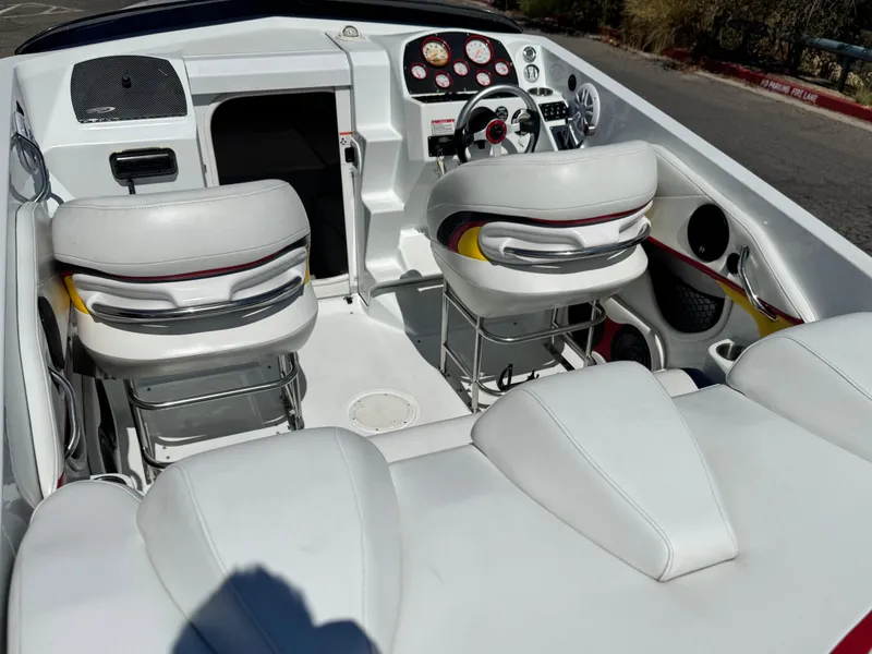 Slide: The Image of 2007 Baja 26 Outlaw boat interior with white seating and dashboard controls. - 11
