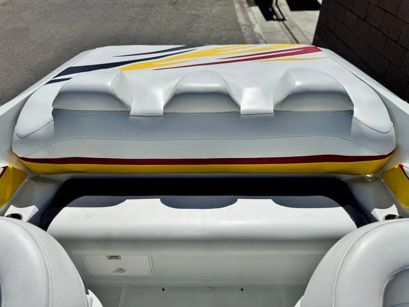 Slide: The Image of 2007 Baja 26 Outlaw boat interior with white and yellow seating, featuring sleek design elements. - 12