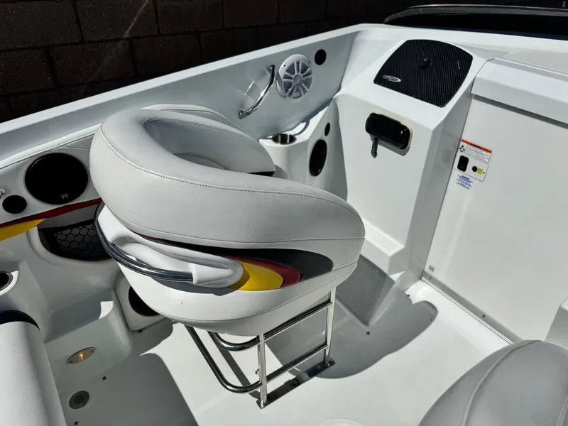 Slide: The Image of 2007 Baja 26 Outlaw boat interior with white seating and dashboard details. - 15