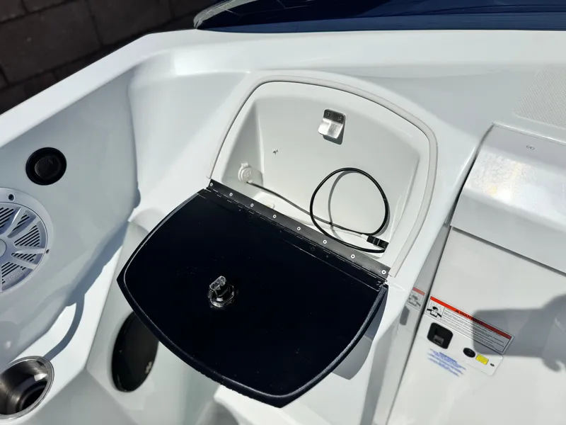 Slide: The Image of 2007 Baja 26 Outlaw boat interior with open storage compartment and speaker. - 16