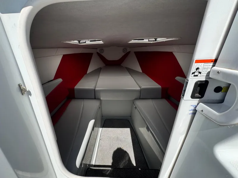 Slide: The Image of Interior cabin of a 2007 Baja 26 Outlaw boat with red and gray seating. - 20