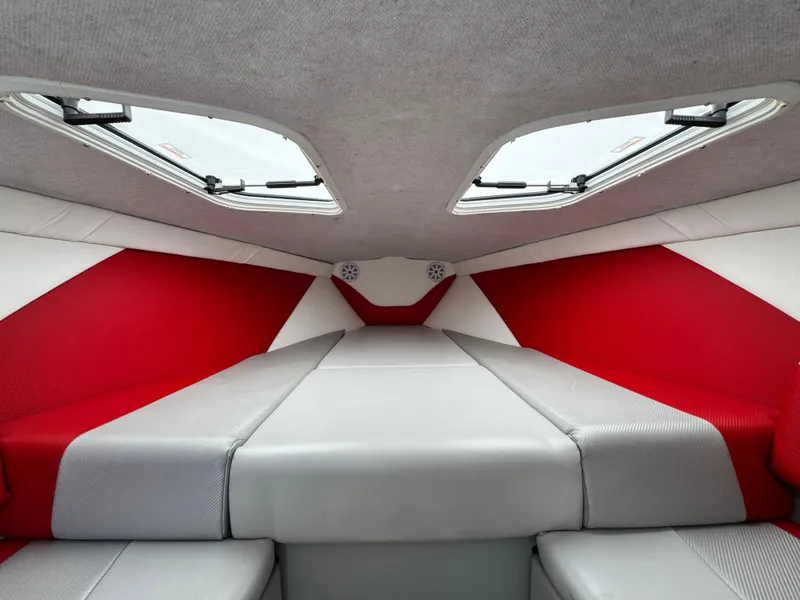 Slide: The Image of Interior of 2007 Baja 26 Outlaw boat with red and gray upholstery. - 21