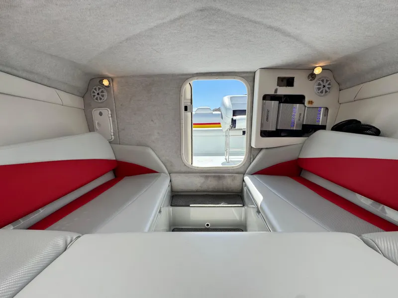 Slide: The Image of Interior of 2007 Baja 26 Outlaw boat with red and white seating. - 23