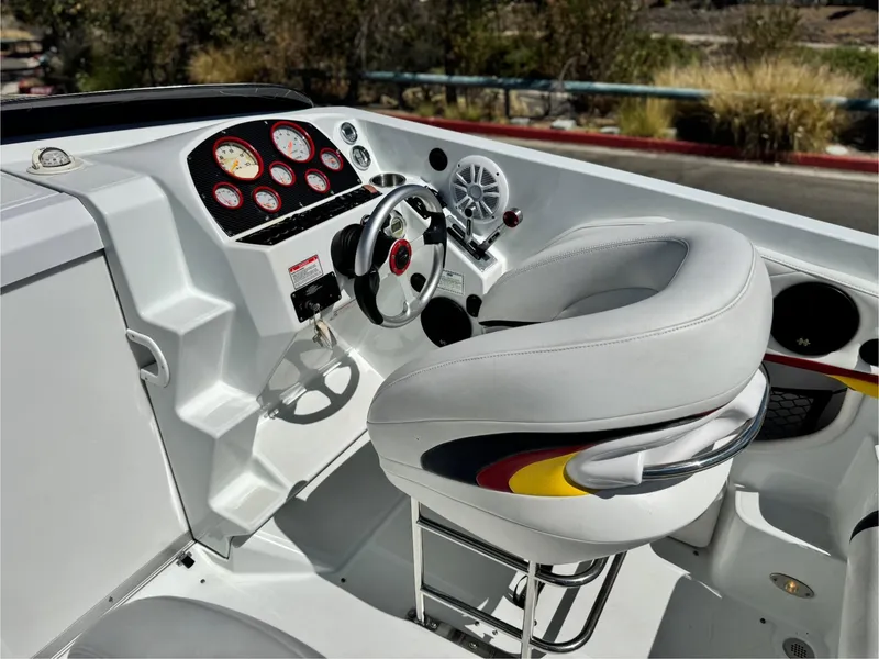 Slide: The Image of 2007 Baja 26 Outlaw boat cockpit with steering wheel and gauges. - 25