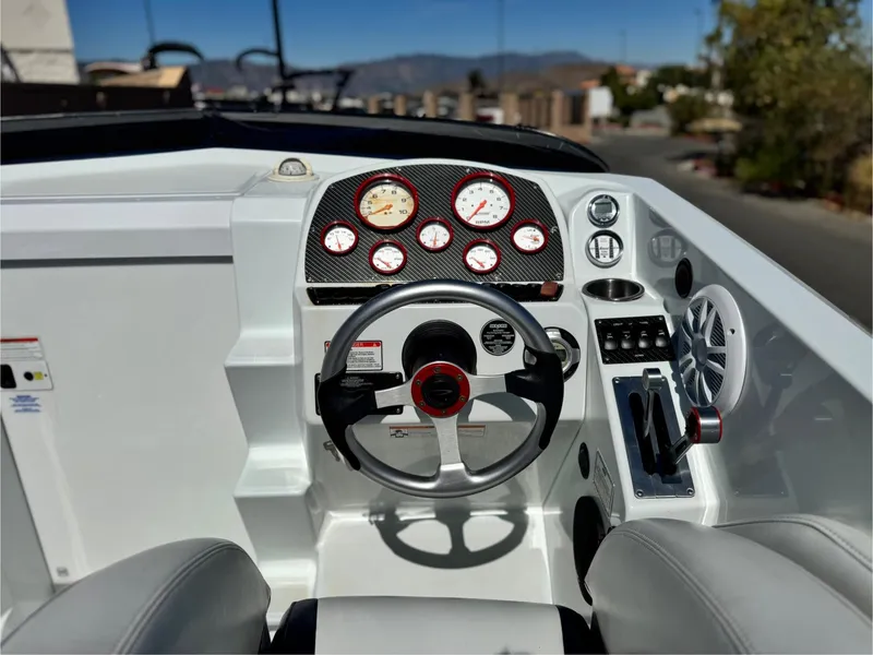 Slide: The Image of 2007 Baja 26 Outlaw boat dashboard with steering wheel and gauges. - 26