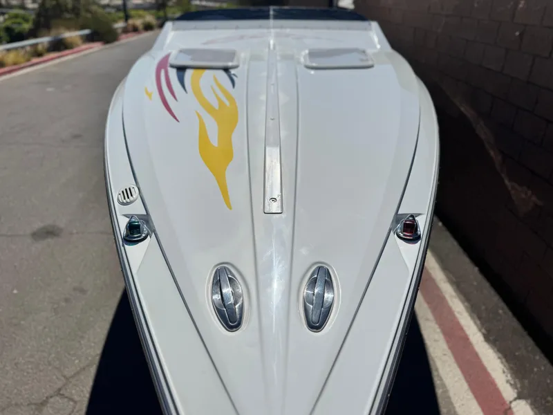 Slide: The Image of 2007 Baja 26 Outlaw boat with flame decals on a sunny day. - 9