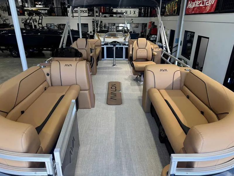Slide: The Image of 2025 Avalon 2385 25 Venture QL pontoon boat with tan seating in showroom. - 11