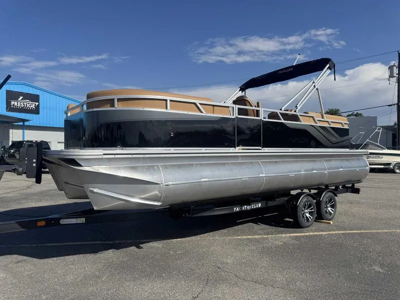 Slide: The Image of 2025 Avalon 2385 25 Venture QL pontoon boat on trailer, parked outdoors. - 4