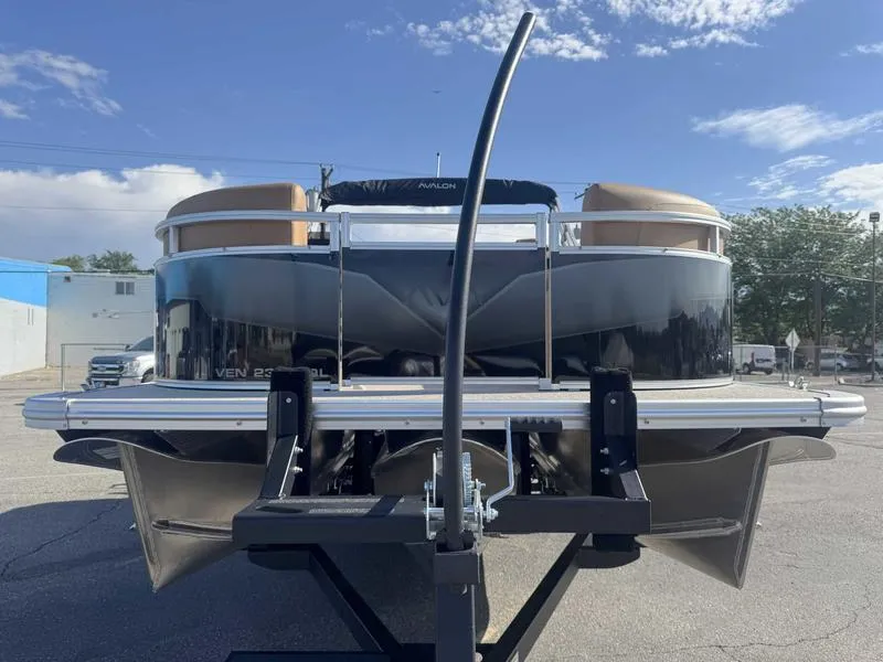 Slide: The Image of 2025 Avalon 2385 25 Venture QL pontoon boat on trailer, sunny day, outdoor setting. - 5