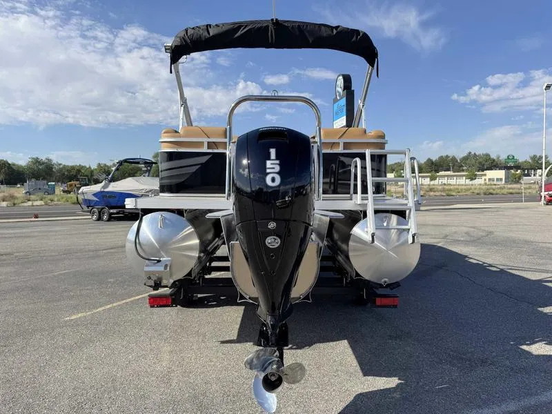 Slide: The Image of 2025 Avalon 2385 25 Venture QL pontoon boat with 150 HP engine, parked outdoors. - 6