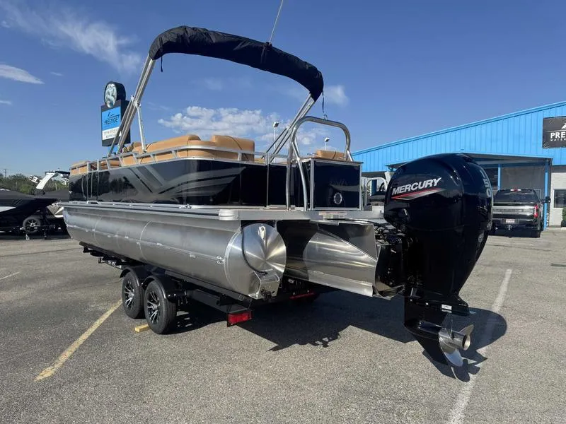 Slide: The Image of 2025 Avalon 2385 25 Venture QL pontoon boat with Mercury outboard motor in parking lot. - 7