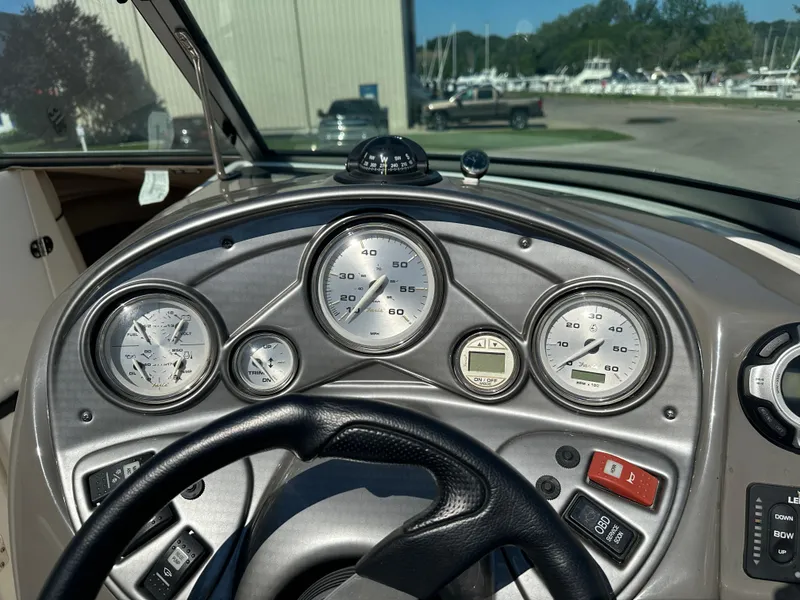 Slide: The Image of Dashboard of a 2014 Rinker Captiva 246 BR boat with gauges and controls. - 10