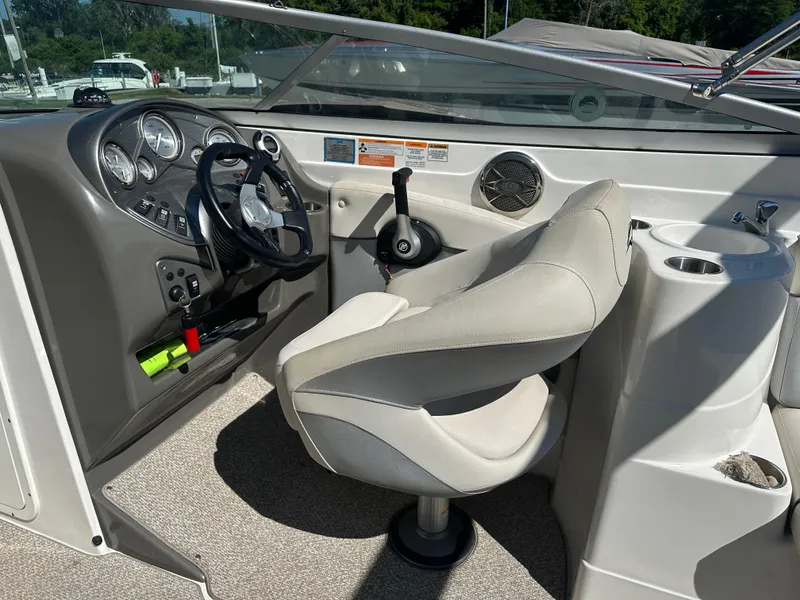 Slide: The Image of 2014 Rinker Captiva 246 BR boat cockpit with steering wheel and control panel. - 11