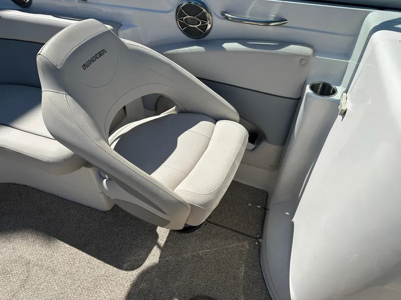 Slide: The Image of 2014 Rinker Captiva 246 BR boat interior with gray seating and speaker. - 12