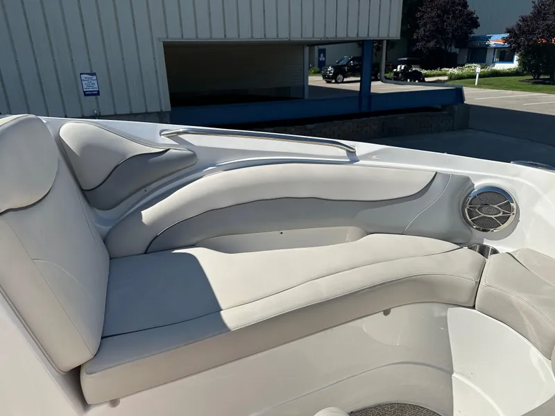 Slide: The Image of 2014 Rinker Captiva 246 BR boat interior with cushioned seating and speaker. - 15
