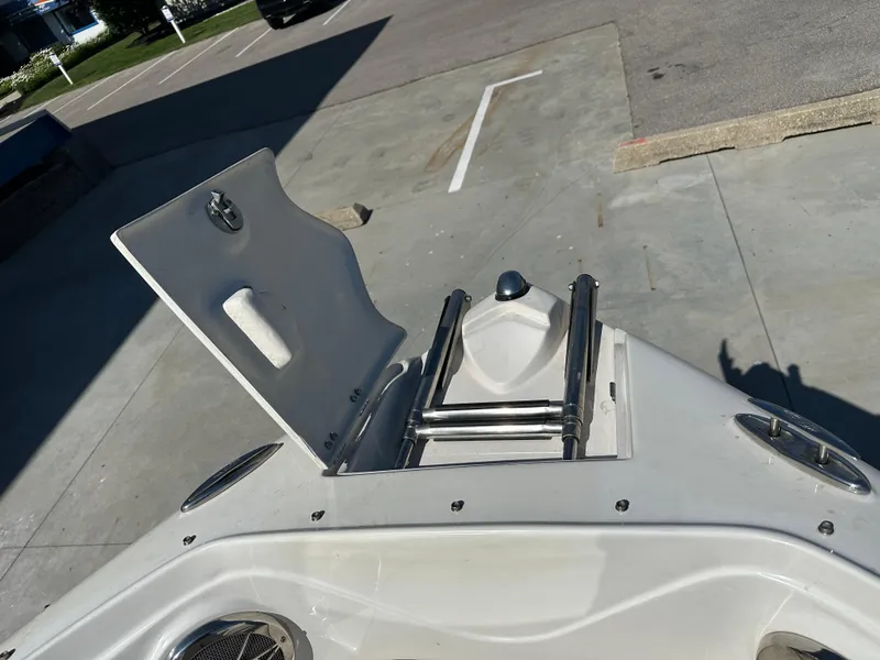 Slide: The Image of 2014 Rinker Captiva 246 BR boat bow with open hatch and ladder. - 20