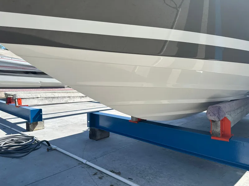 Slide: The Image of 2014 Rinker Captiva 246 BR boat hull on a blue support stand. - 3