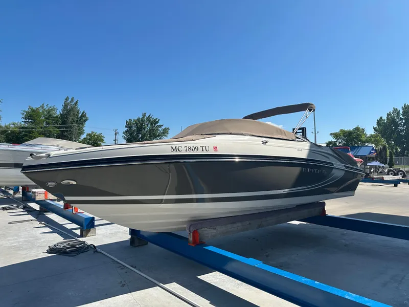 Slide: The Image of 2014 Rinker Captiva 246 BR boat on display in a sunny outdoor setting. - 4