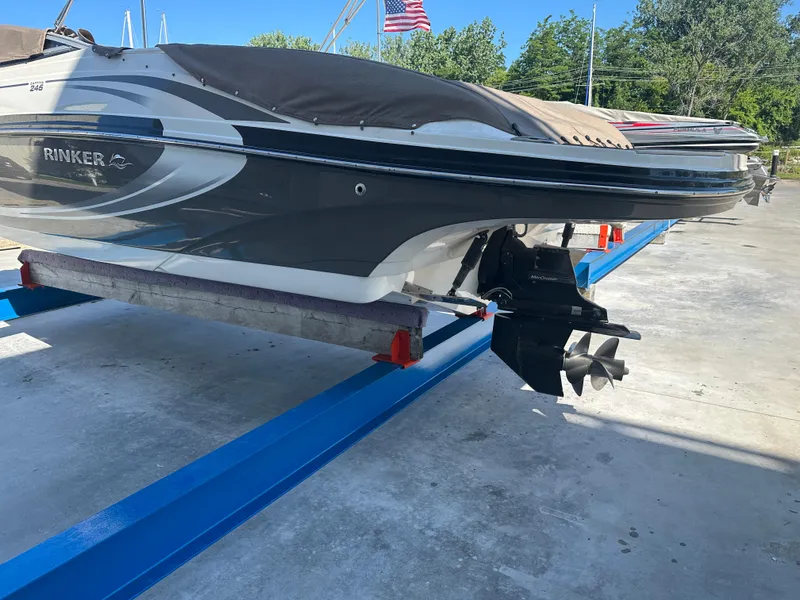 Slide: The Image of 2014 Rinker Captiva 246 BR boat on a blue lift, outdoor setting. - 5