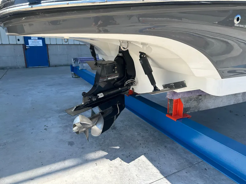 Slide: The Image of 2014 Rinker Captiva 246 BR boat on stand, featuring MerCruiser outdrive. - 7