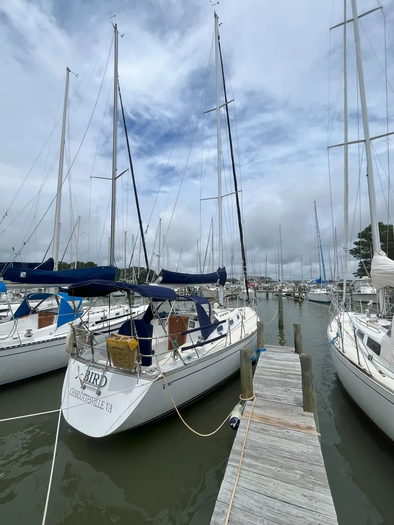 The Image of Sailboat docked at marina, Tartan 31 model, 1988, under cloudy sky. - 1