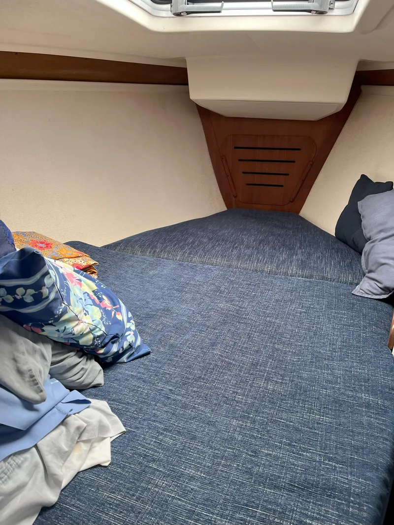 Slide: The Image of Cozy cabin interior of 1988 Tartan 31 sailboat with blue bedding and pillows. - 18